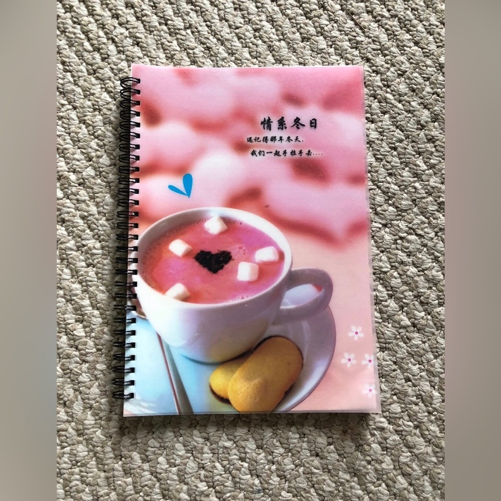 Pink spiral notebook with hot chocolate and marshmallows design